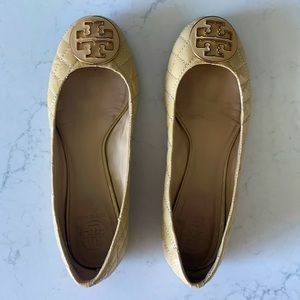 Tory Burch tan quilted patent leather flats.